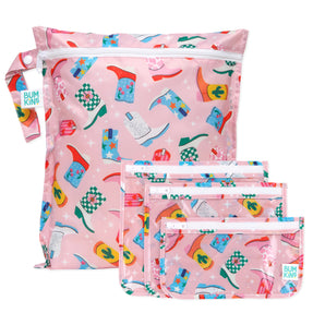 Bumkins The Chaos Coordinator Essential 4-Piece Set: Boots—4 pink waterproof bags with a colorful cowboy boot print and zipper closures.