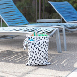 Bumkins Wet/Dry Bag: Hearts sits by blue lounge chairs, holding towels and pool essentials.