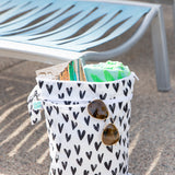 The Bumkins Wet Bag + Wet/Dry Bag Set: Hearts holds poolside essentials on a sunny day—perfect for summer packing.