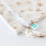 Close-up of Bumkins Wet/Dry Bag: Palm Daze on a white background, with focus on the zippers and snap-closure handle.