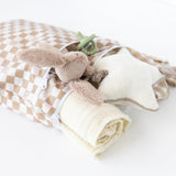 Bumkins Wet/Dry Bag: Sand Check with plush star, rabbit, pacifier, and blanket on a white background.