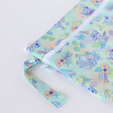 Close-up of Bumkins Wet/Dry Bag: Aloha Stitch on a white background, with focus on the zipper, strap, and Disney Baby logo tag.