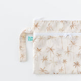Bumkins Wet/Dry Clutch: Palm Daze, half visible, lays on a white background.