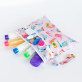 Bumkins Wet/Dry Clutch: Boots opens to show travel-sized bottles and containers on a white background.