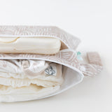 The Bumkins Wander Wet Bag + Wet/Dry Clutch + Clear Travel Bag set holds diapers, wipes & more—essentials packed in style.