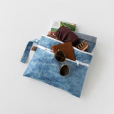Roamio by Bumkins Wet/Dry Clutch: Crushed Denim stores sunglasses, passport, clothes, and a hair clip on a white background.