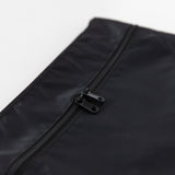 Close-up of Bumkins Wet/Dry Clutch: Black, featuring dual zipper pulls and waterproof fabric, on a white background.