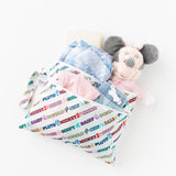 Bumkins Wet/Dry Clutch: Mickey & Friends Varsity holds clothes, diapers, and a plush toy on a white background.