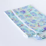 Bumkins Wet/Dry Clutch: Aloha Stitch lays on a white background, with focus on the zippers and snap closure of the handle.