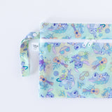 Bumkins Wet/Dry Clutch: Aloha Stitch is half visible as it lays flat on a white background.