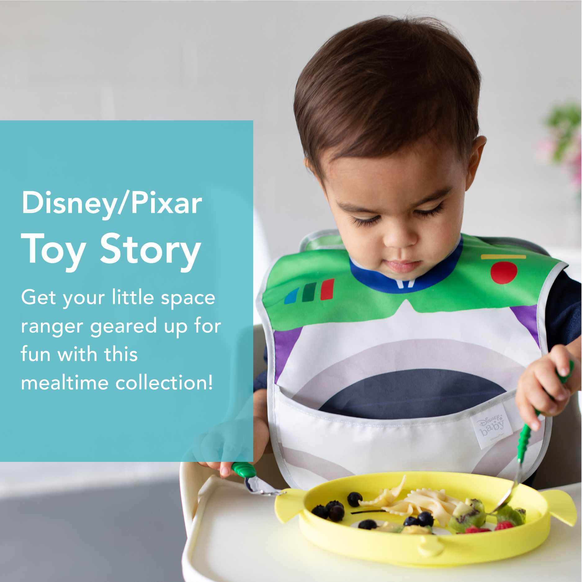 A toddler in a Buzz Lightyear bib from Toy Story, sitting in a high chair. Theyre focused on eating from a yellow plate with various foods. Text promotes the mealtime collection.