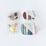 The Bumkins Palm Daze set includes 2 packing cubes and 3 clear travel bags to organize clothes, makeup, and toiletries.