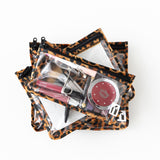 Roamio by Bumkins Clear Travel Bag 3 Pack: Leopard is stacked on a white background, filled with cosmetics.
