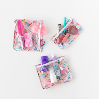 Three bags from Bumkins The Playdate Planner Deluxe 5-Piece Set: Boots hold hair accessories and makeup on a white background.