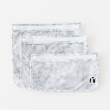 Roamio by Bumkins Clear Travel Bag 3 Pack: Disco Check lays stacked on a white background.