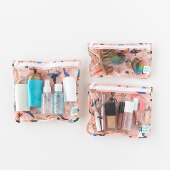 Three bags from Bumkins The Playdate Planner Deluxe 5-Piece Set: Yoga Pals hold toiletries, makeup, & accessories on a white background.