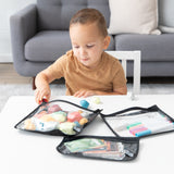 A young child plays as Bumkins Wet Bag + Clear Travel Bag 3 Pack Set keeps blocks and markers organized at a white table.
