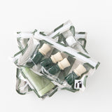Roamio by Bumkins Clear Travel Bag 3 Pack: Clubhouse Stripe is stacked on a white background, filled with travel-sized bottles.