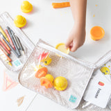 A child packs toy ducks into a Bumkins Wet Bag + Clear Travel Bag 3 Pack Set: Wander—travel-ready for busy parents.