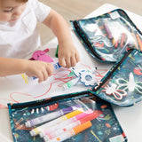 A child colors and plays as art supplies stay organized in Bumkins Wet Bag + Clear Travel Bag 3 Pack Set: Jungle.