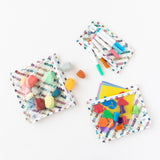 Bumkins Clear Travel Bag 3 Pack: Mickey & Friends Varsity filled with markers and art supplies are laid out on a white background.