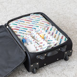 A black suitcase is packed with Bumkins Disney Packing Cube 2 Pack + Clear Travel Bag 3 Pack Set on a light carpeted floor.