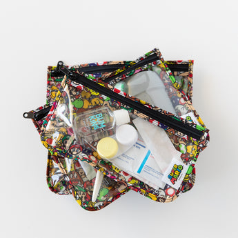 Bumkins Clear Travel Bag 3-Pack: Super Mario™ Mashup lays stacked on a white background, filled with TSA-compliant bottles and toiletries.
