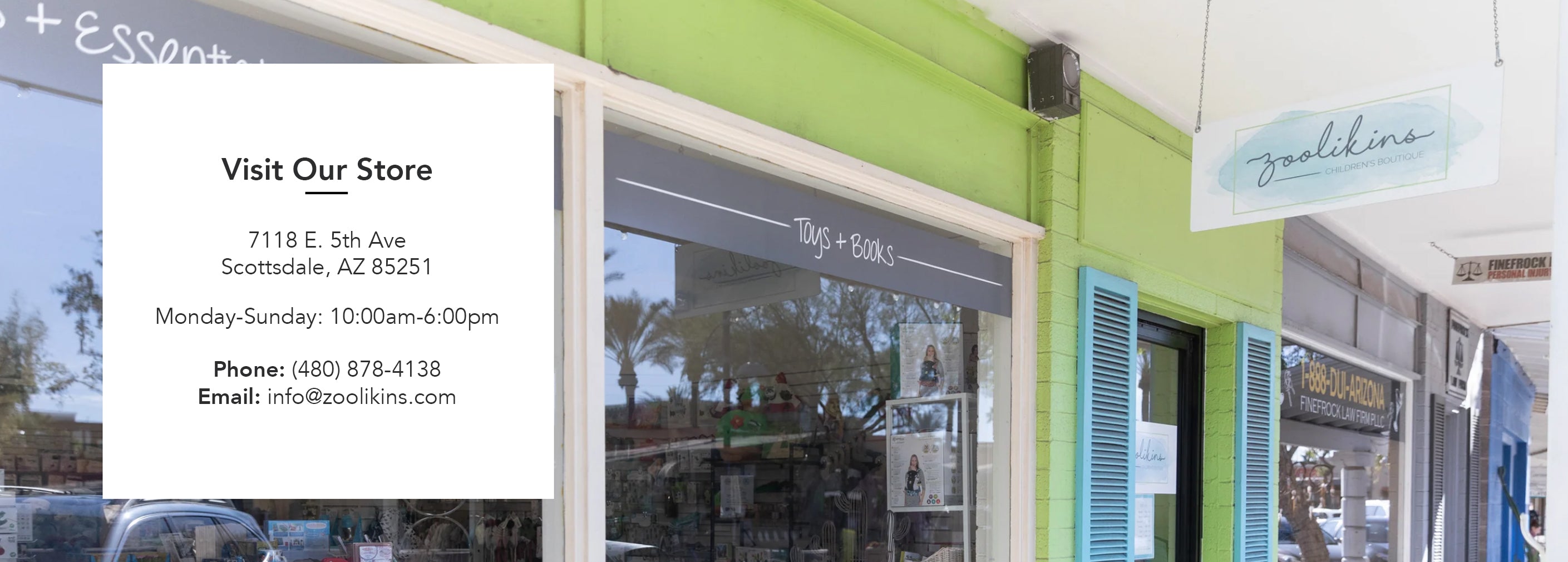 A store exterior with a bright green facade, displaying toys and essentials. A sign provides the address: 7118 E. 5th Ave, Scottsdale, AZ 85251. Store hours are Monday-Sunday, 10:00am-6:00pm. Contact: Phone (480) 878-4138, Email: info@zoolikins.com.