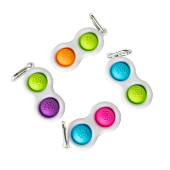 Four Simpl Dimpls by Fat Brain Toy Co with two colorful silicone buttons on white frames for tactile stimulation.
