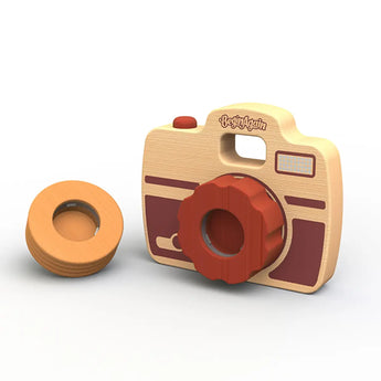 The Shutterbug Camera by Begin Again is a sustainably harvested rubberwood toy with red accents and an orange lens. Detachable viewfinder included.