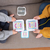 Two kids on a couch use colorful string to lace through boards from Fat Brain Toy Cos Sew Fast, excitedly following challenge cards.