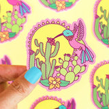 Turtle Soups Vinyl Sticker, Desert Hummingbird features a vibrant hummingbird and cactus against a sun, perfect for weatherproof decor.