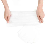 Hands hold Bumkins Diaper Liners on a white background, demonstrating their 100% viscose design.