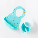 Bumkins Silicone First Feeding Set: Blue sits near a blue silicone bib on a white background.