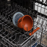 Bumkins Silicone First Feeding Set: Clay sits in the top rack of an open dishwasher.