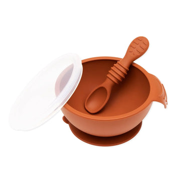 Bumkins Silicone First Feeding Set: Clay includes a bowl with suction bottom, a matching spoon, and a transparent lid.