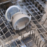 Bumkins Silicone First Feeding Set: Gray sits in the top rack of an open dishwasher.
