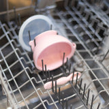 Bumkins Silicone First Feeding Set: Pink sits in the top rack of an open dishwasher.