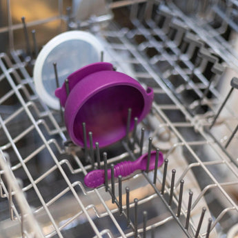 Bumkins Silicone First Feeding Set: Purple sits in the top rack of an open dishwasher.