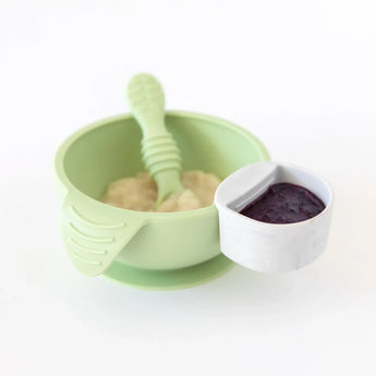 Bumkins Silicone First Feeding Set: Sage with applesauce and a gray cup with berry puree on a white background.