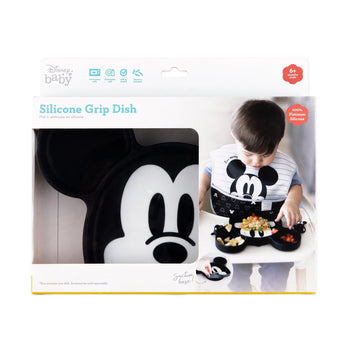 Bumkins Silicone Grip Dish: Mickey Mouse in a white packaging box with a photo of a child and a clear window partially displaying the dish.