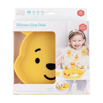 Bumkins Silicone Grip Dish: Winnie The Pooh in a white packaging box with a photo of a child and a clear window partially displaying the dish.