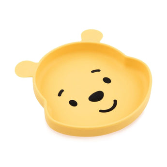 Bumkins Silicone Grip Dish: Winnie The Pooh is a yellow bear-shaped silicone dish with one open section, a face, ears, and suction base.