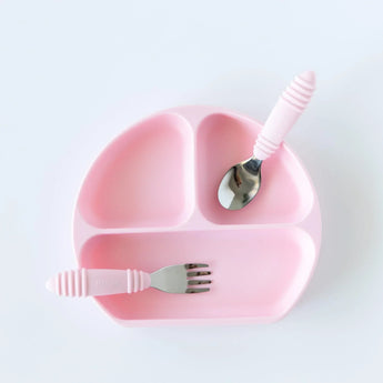 Bumkins Silicone Grip Dish: Pink with matching utensils on top on a white background.