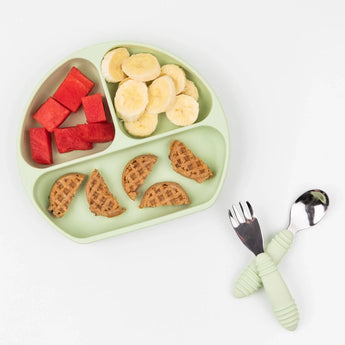 Bumkins Silicone Grip Dish: Sage holds watermelon, banana slices, and waffles on a white background, with matching utensils nearby.