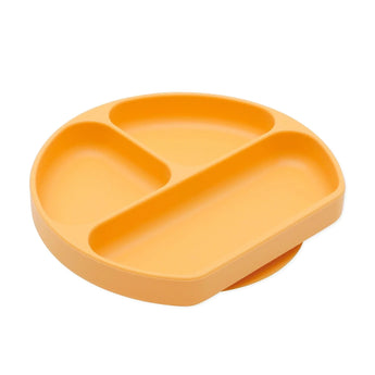 Bumkins Silicone Grip Dish: Tangerine is an orange round plate with 3 compartments and a suction base, made of food-safe silicone.