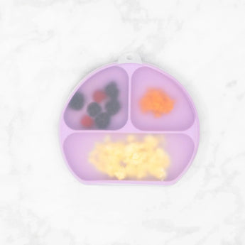 Bumkins Silicone Grip Dish with Lid (3 Section): Lavender with berries, orange mash, and scrambled eggs on a white marble surface.