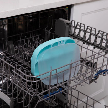 Bumkins Silicone Grip Dish with Lid (5 Section): Blue sits in the top rack of an open dishwasher.