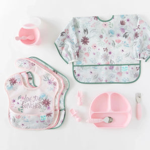 Bumkins Ultimate Gift Set - Floral & Lace includes two kinds of bibs, a bowl with spoon, two sets of utensils, and a silicone dish.