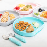 Four plates with food, including Bumkins Silicone Grip Plate: Blue, are arranged neatly with utensils on a marble surface.